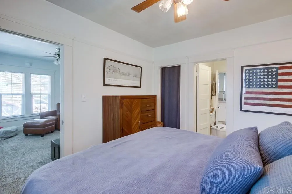 4217 Third Avenue San Diego, CA 92103 - Photo 15 of 16 a bedroom with a bed and a chandelier
