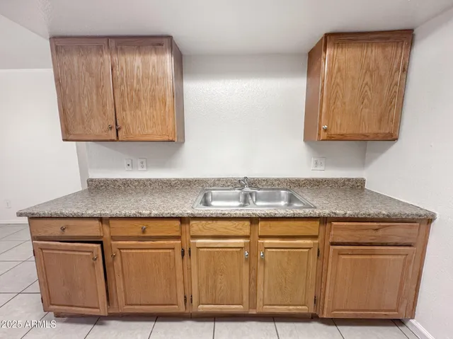 an empty room with chandelier fan