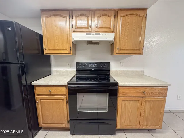 a kitchen with stainless steel appliances a stove a sink and cabinets