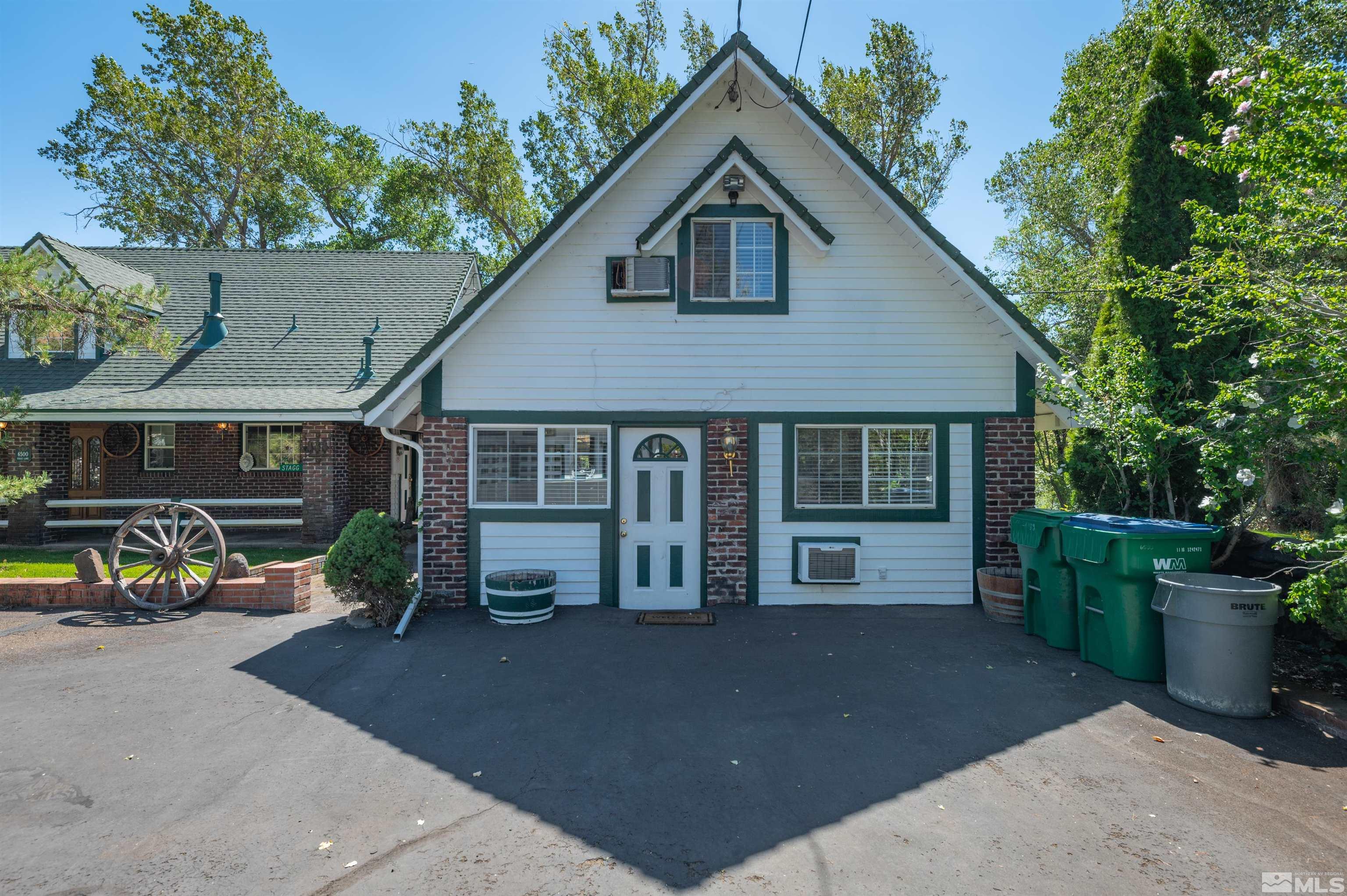 6500 Stagg Lane Reno, NV 89523 - Photo 20 of 24 a front view of a house with a yard and garage