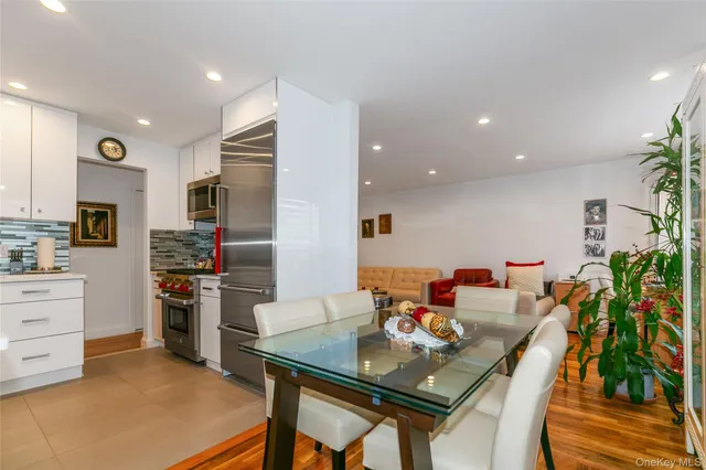a view of a dining room with furniture and a kitchen