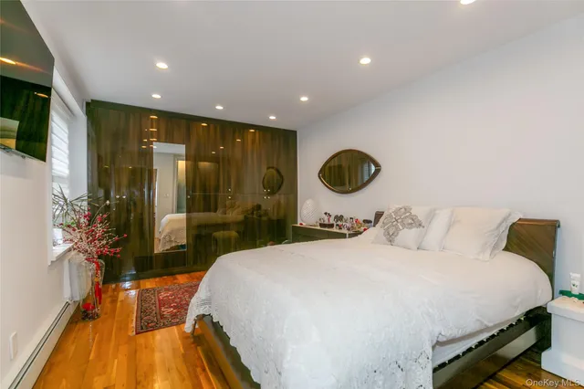 a bedroom with a bed and a large window