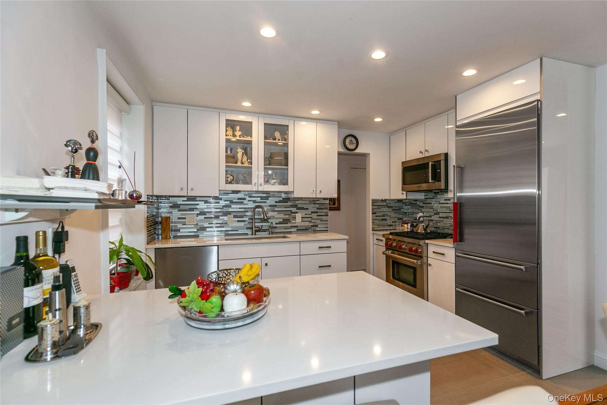 195 South Middle Neck Road, Unit 2H Great Neck, NY 11021 - Photo 17 of 25 a kitchen with stainless steel appliances kitchen island granite countertop a sink and refrigerator