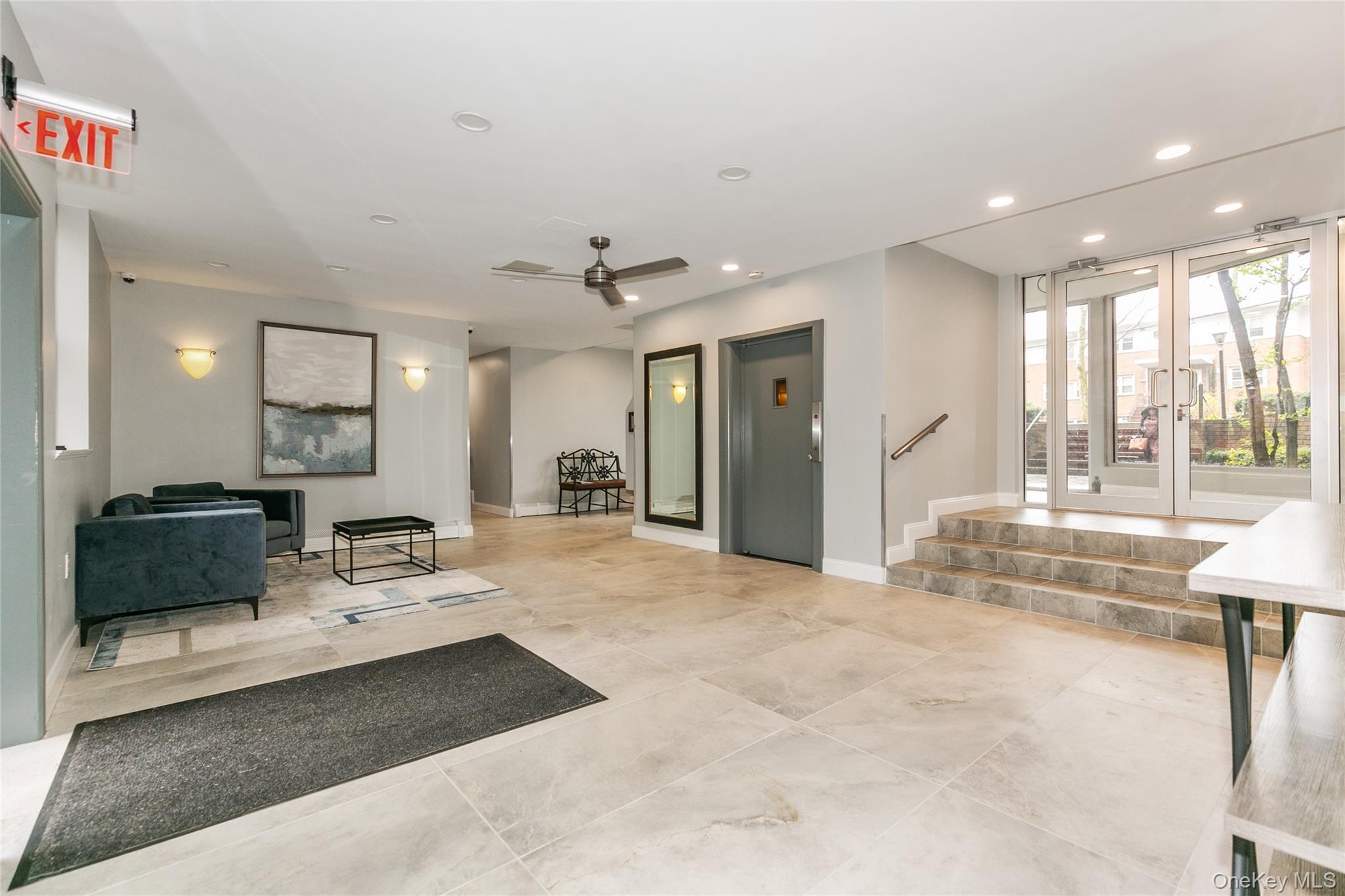 195 South Middle Neck Road, Unit 2H Great Neck, NY 11021 - Photo 23 of 25 a living room with furniture and a table