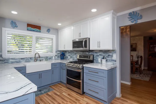 a kitchen with stainless steel appliances granite countertop a sink stove and refrigerator