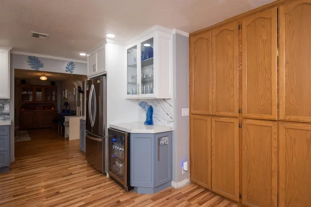 a kitchen with stainless steel appliances a refrigerator and cabinets
