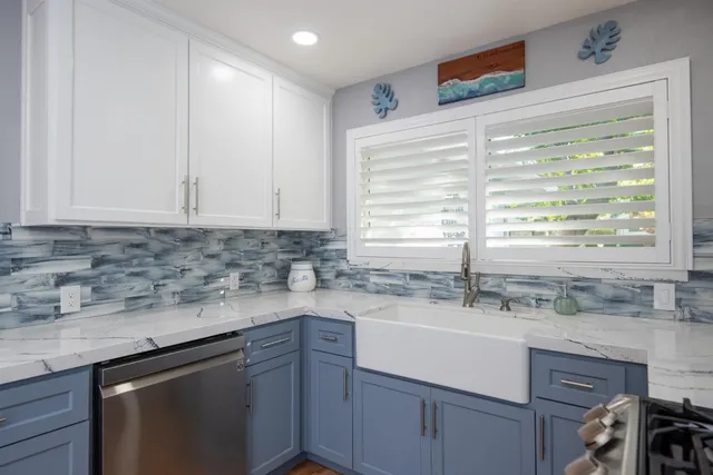 a kitchen with a sink cabinets and window