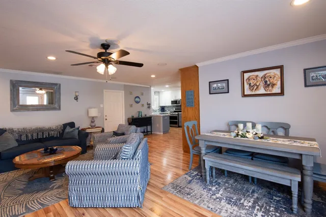 a living room with furniture a rug and a window