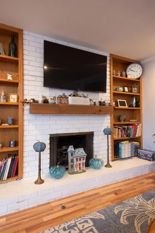 a living room with fireplace furniture and a flat screen tv
