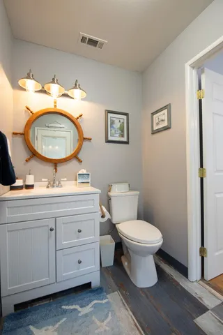 a bathroom with a toilet a sink and a mirror