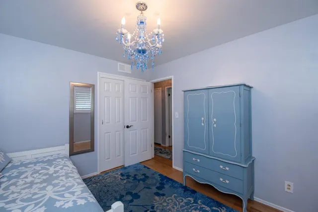 a view of a bedroom with wooden floor and hallway