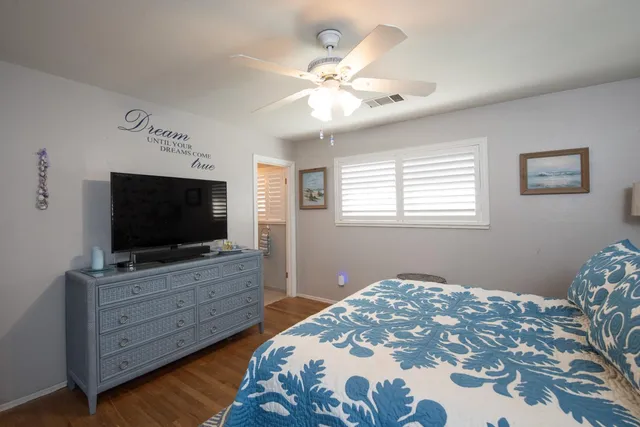 a bedroom with a bed and flat screen tv