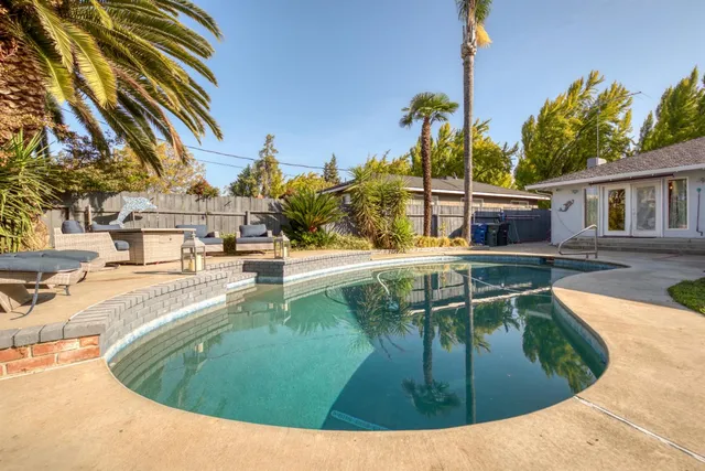a view of a swimming pool with a patio