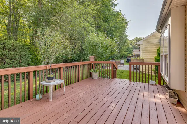a view of a wooden deck with a yard