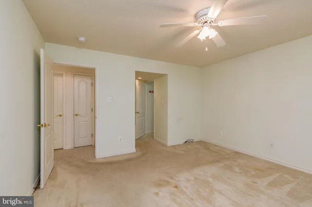 an empty room with fan and fan