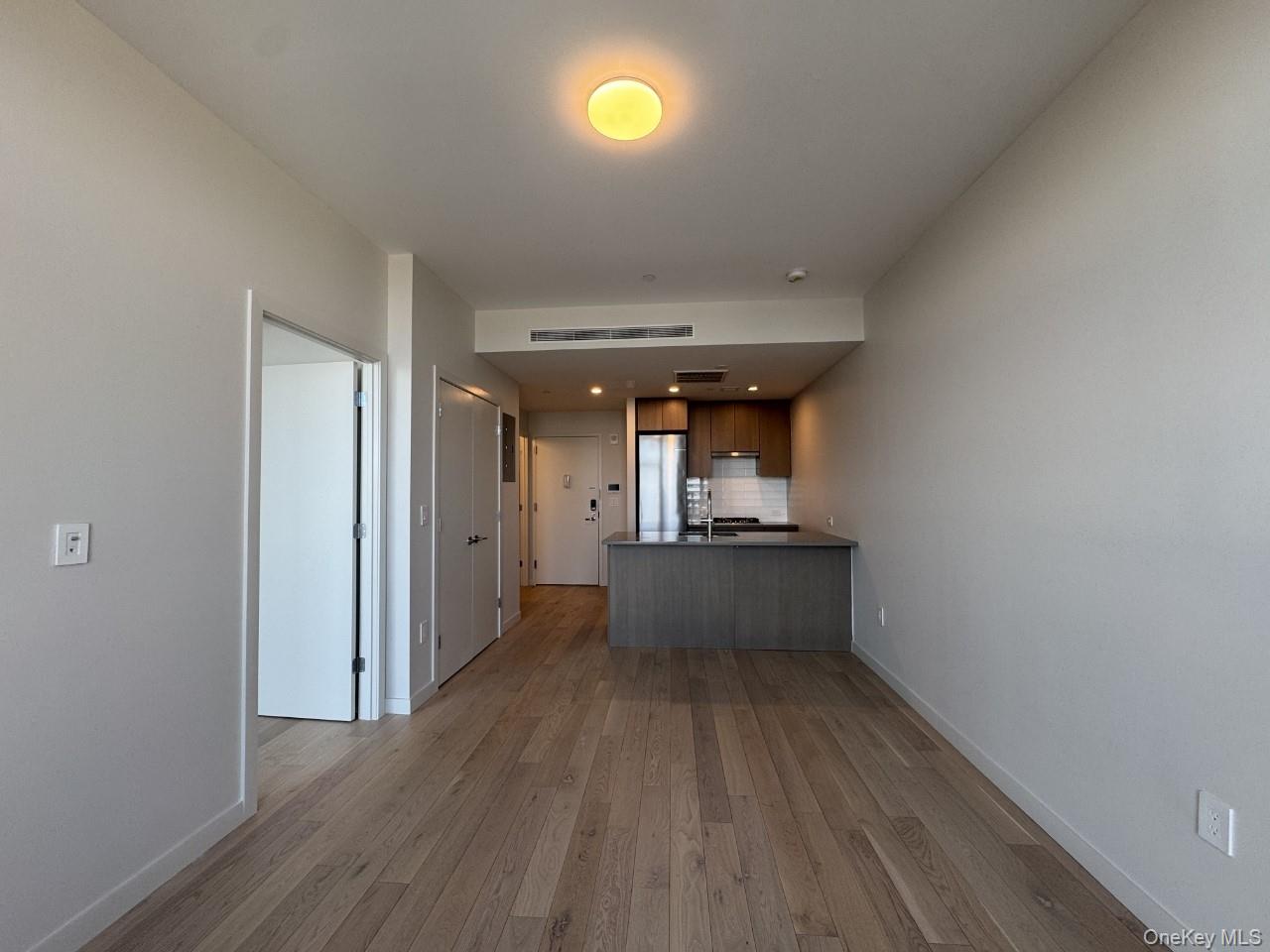 131-02 40th Road, Unit 9O Queens, NY 11354 - Photo 15 of 24 a view of a room with wooden floor