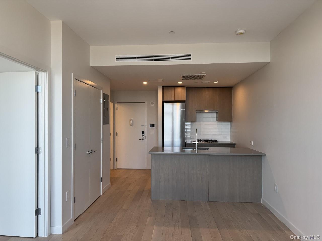 131-02 40th Road, Unit 9O Queens, NY 11354 - Photo 17 of 24 a view of kitchen with refrigerator and window
