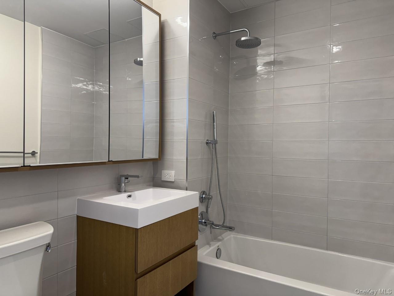 131-02 40th Road, Unit 9O Queens, NY 11354 - Photo 20 of 24 a bathroom with a sink a toilet and shower