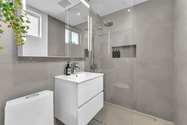 a bathroom with a sink a vanity and a mirror