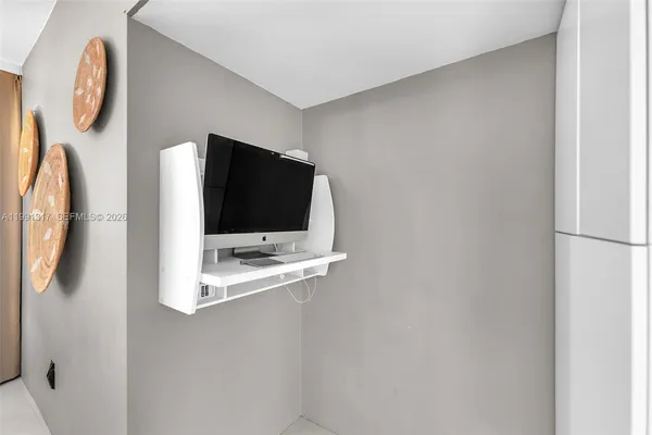 a living room with a flat screen tv and a wall painting