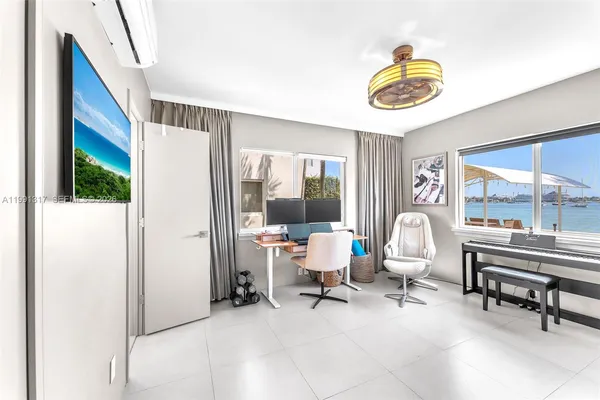 a living room with furniture and a floor to ceiling window