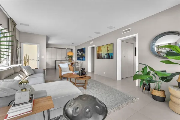 a living room with furniture and a potted plant