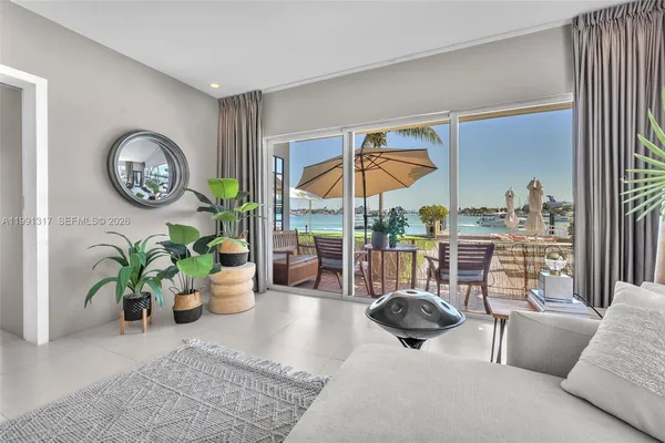 a livingroom with furniture and potted plants