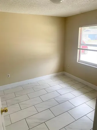 a bathroom with a granite countertop sink toilet and mirror