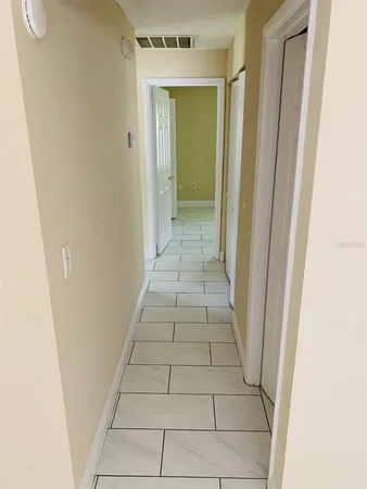 a kitchen with a refrigerator sink and cabinets