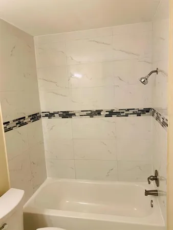 a bathroom with a shower a toilet and a shower