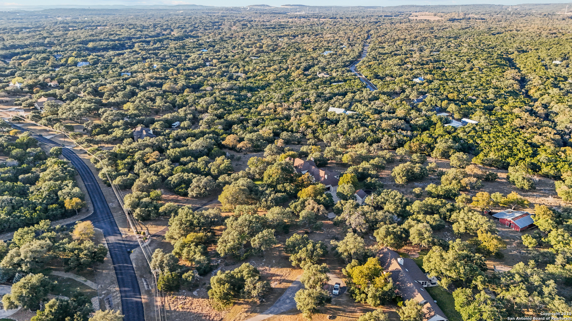 8040 Rolling Acres Trail Fair Oaks Ranch, TX 78015 - Photo 2 of 65 an aerial view of house with yard and mountain view in back