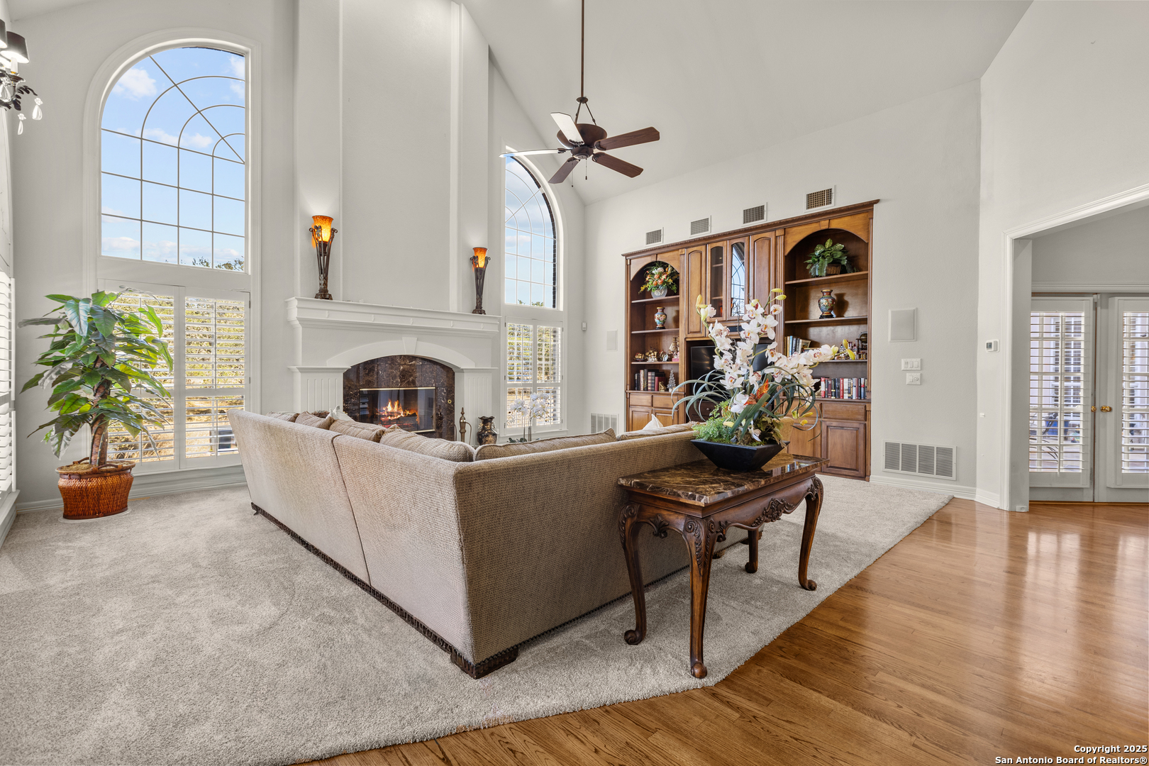 8040 Rolling Acres Trail Fair Oaks Ranch, TX 78015 - Photo 22 of 65 a living room with furniture and a fireplace