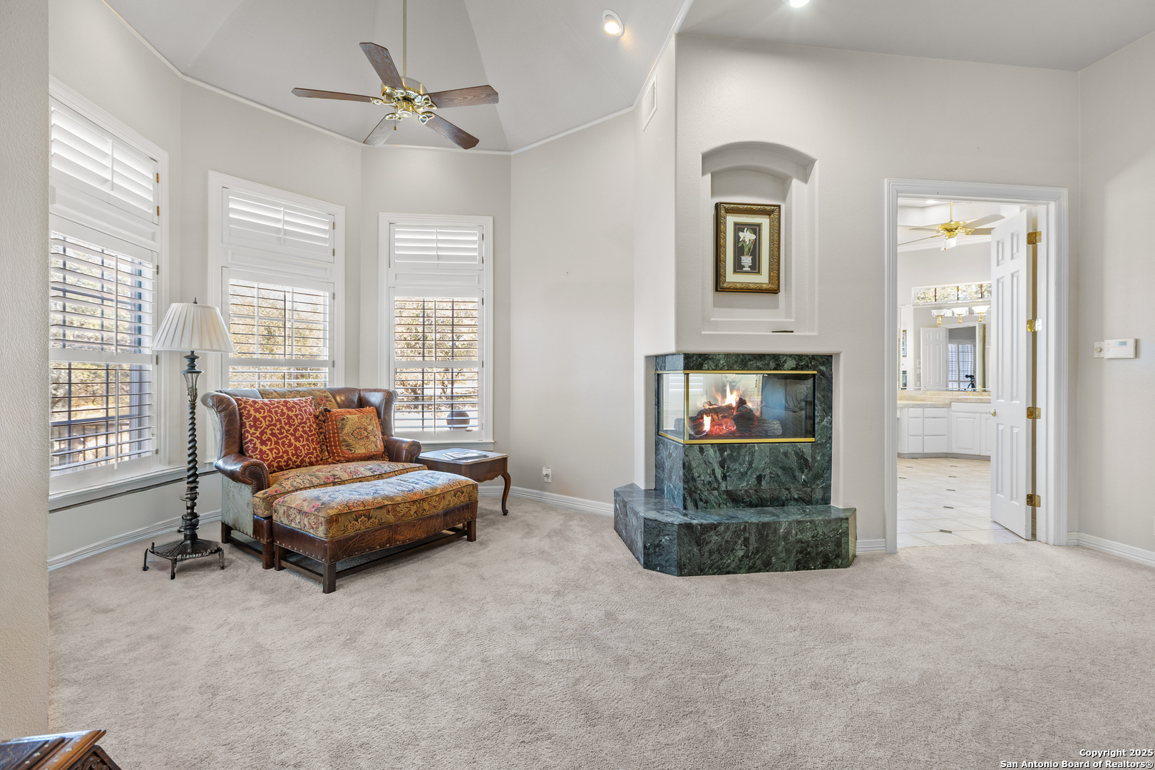 8040 Rolling Acres Trail Fair Oaks Ranch, TX 78015 - Photo 26 of 65 a living room with furniture and a fireplace
