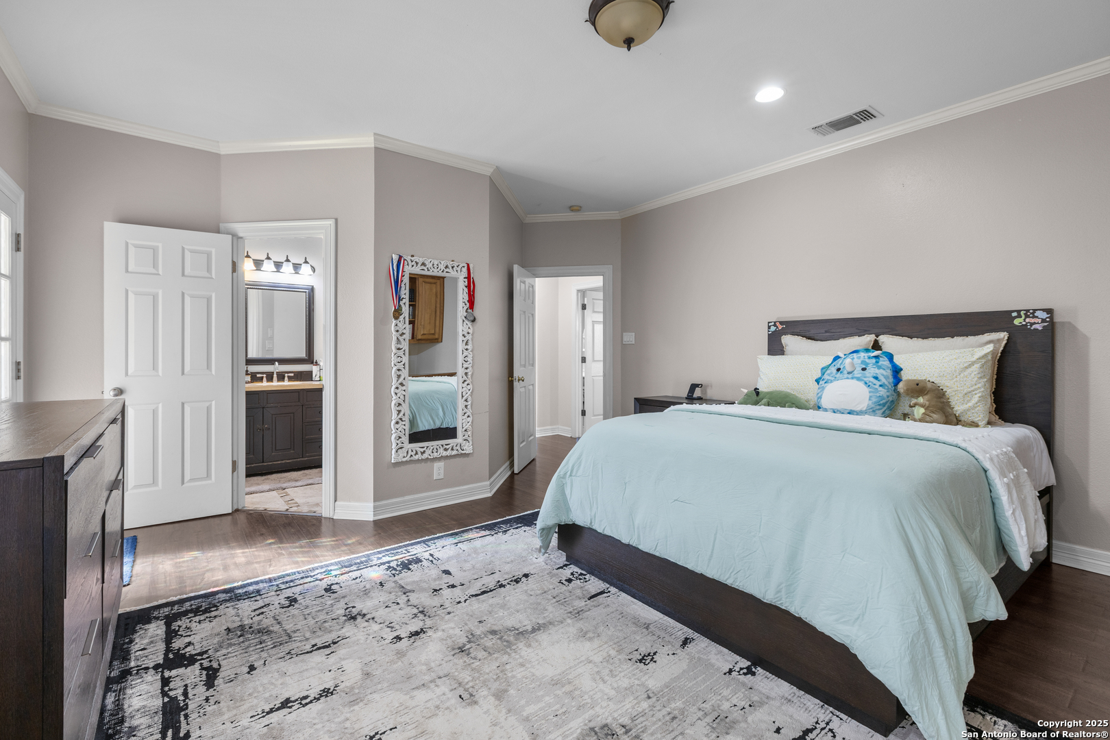 8040 Rolling Acres Trail Fair Oaks Ranch, TX 78015 - Photo 45 of 65 a spacious bedroom with a bed and cabinets