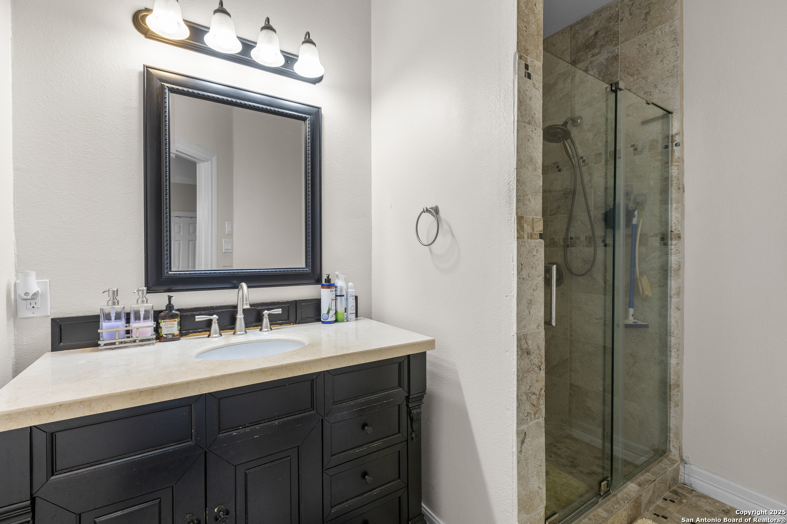8040 Rolling Acres Trail Fair Oaks Ranch, TX 78015 - Photo 46 of 65 a bathroom with a double vanity sink and a mirror