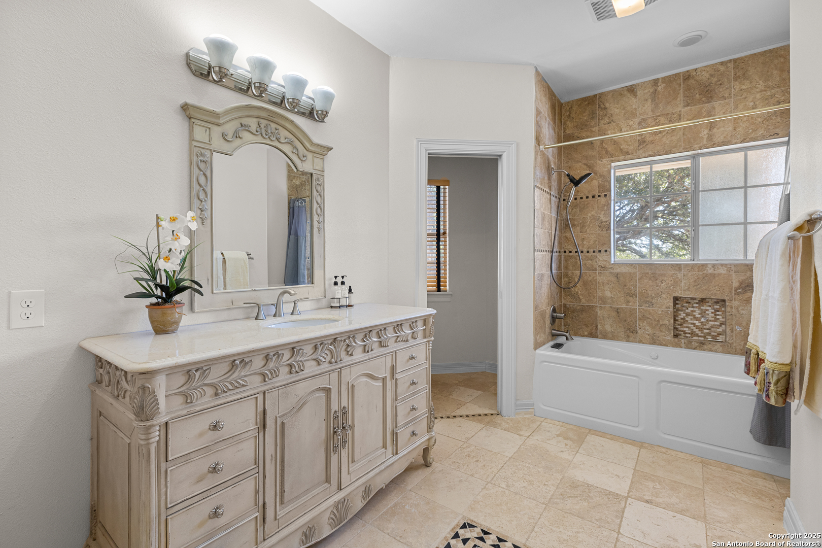 8040 Rolling Acres Trail Fair Oaks Ranch, TX 78015 - Photo 50 of 65 a bathroom with a double vanity sink mirror and bathtub