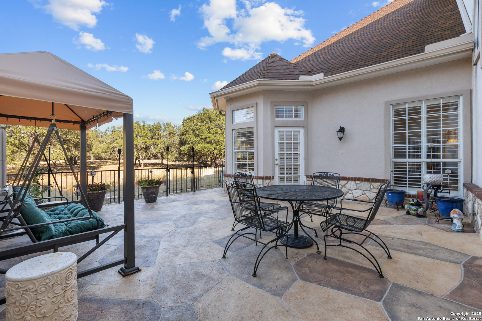 8040 Rolling Acres Trail Fair Oaks Ranch, TX 78015 - Photo 56 of 65 a view of a patio with a table and chairs