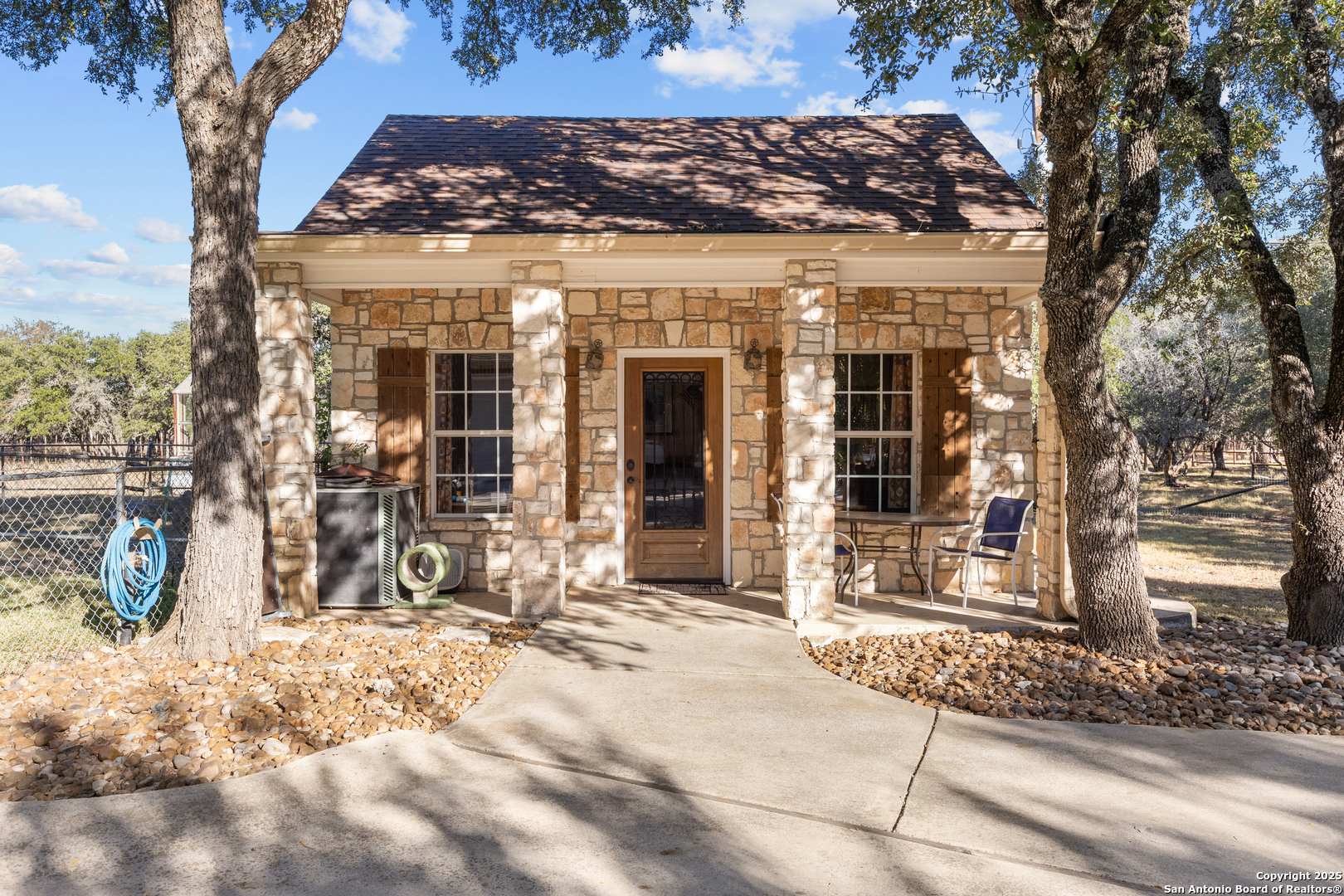 8040 Rolling Acres Trail Fair Oaks Ranch, TX 78015 - Photo 57 of 65 a front view of a building with a garden