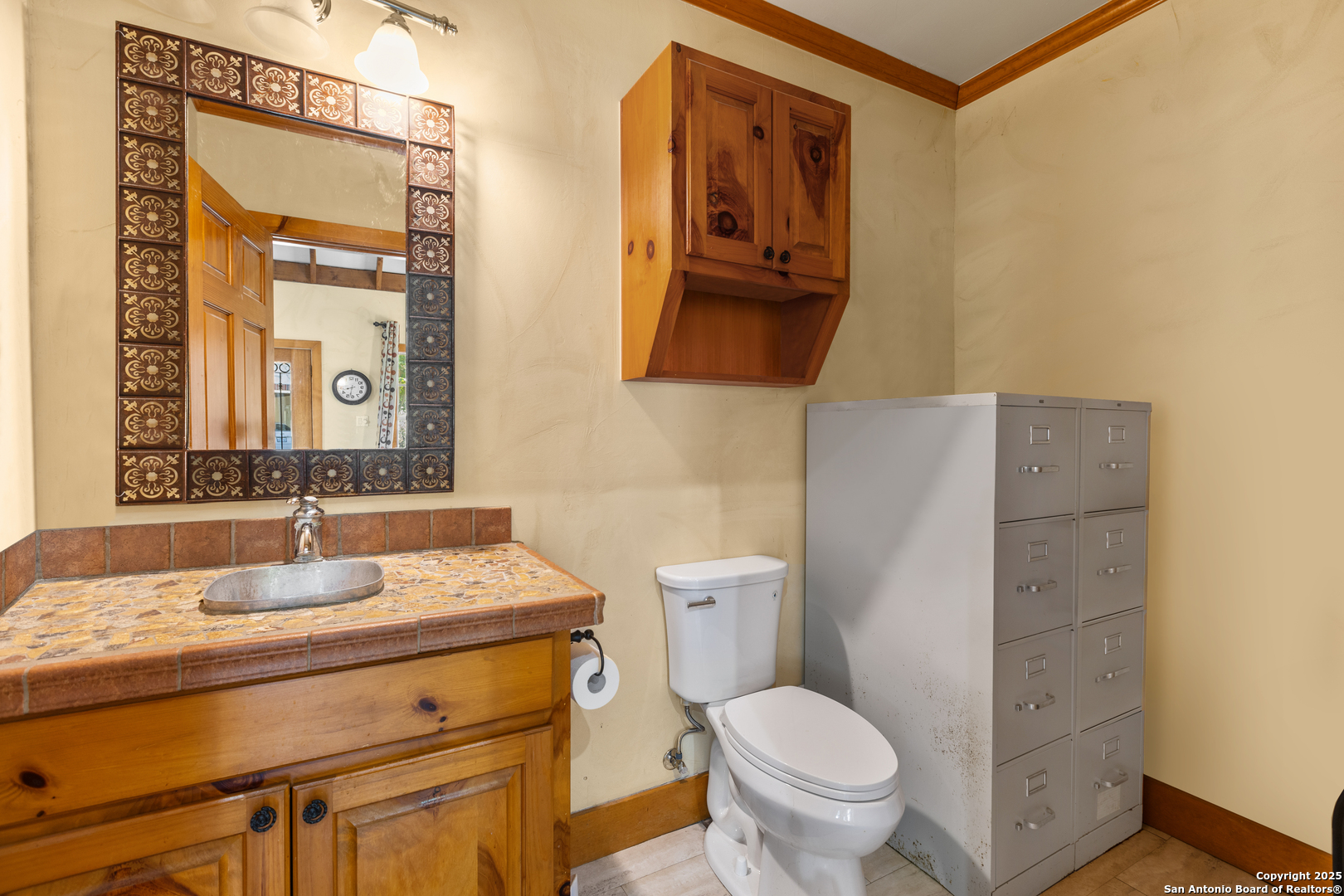 8040 Rolling Acres Trail Fair Oaks Ranch, TX 78015 - Photo 59 of 65 a bathroom with a granite countertop toilet sink and mirror