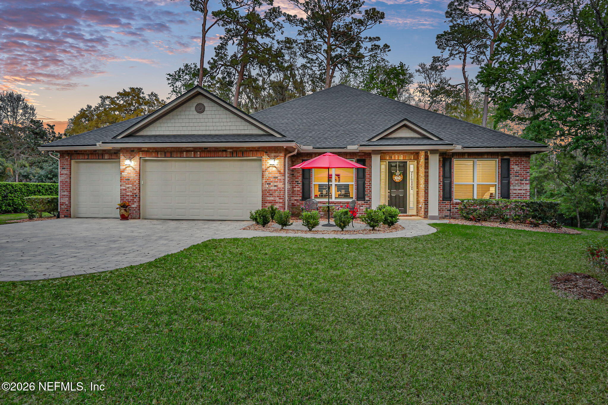 a front view of a house with a garden and yard