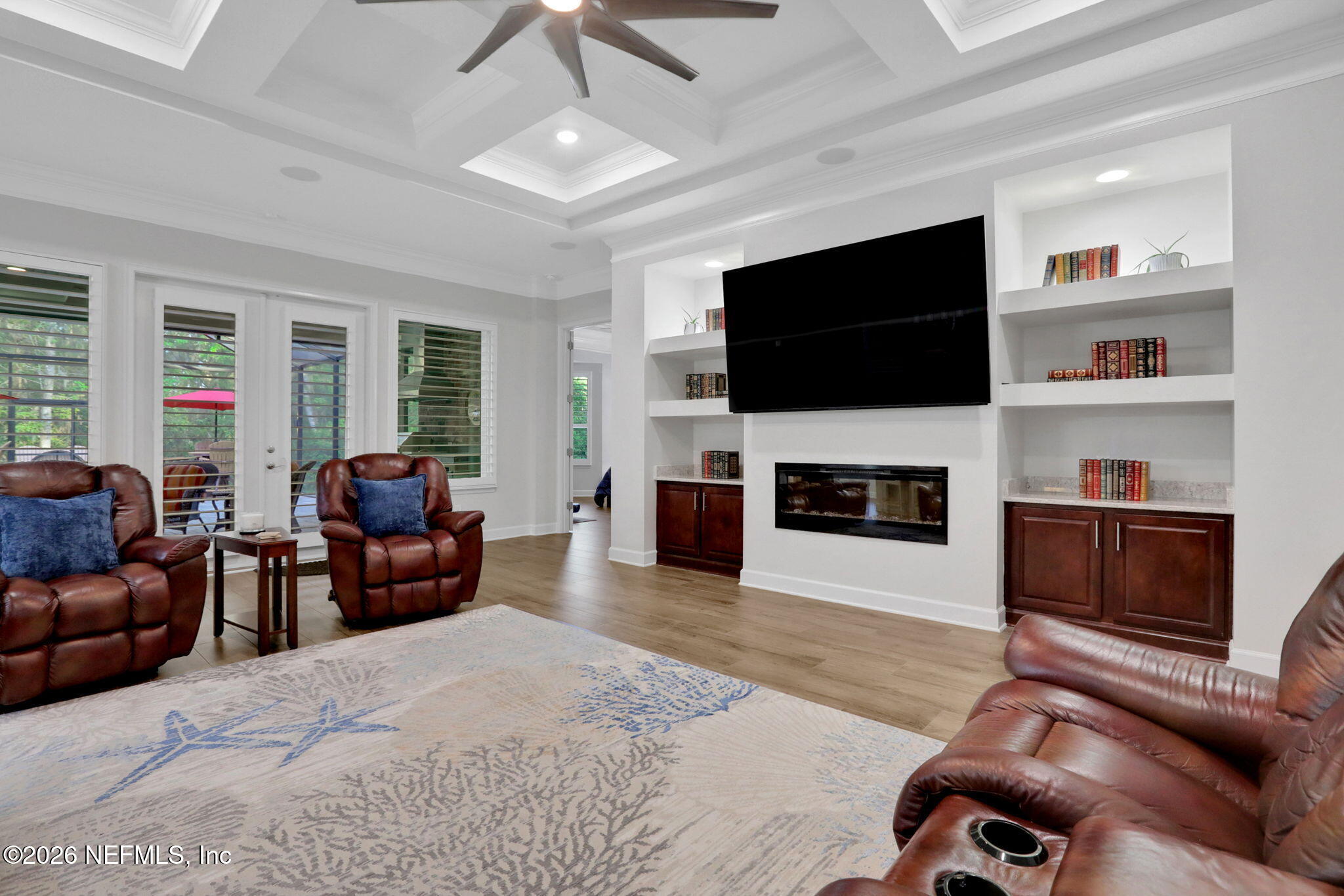 4460 Barkoskie Road Jacksonville, FL 32258 - Photo 15 of 80 a living room with furniture a flat screen tv and a fireplace