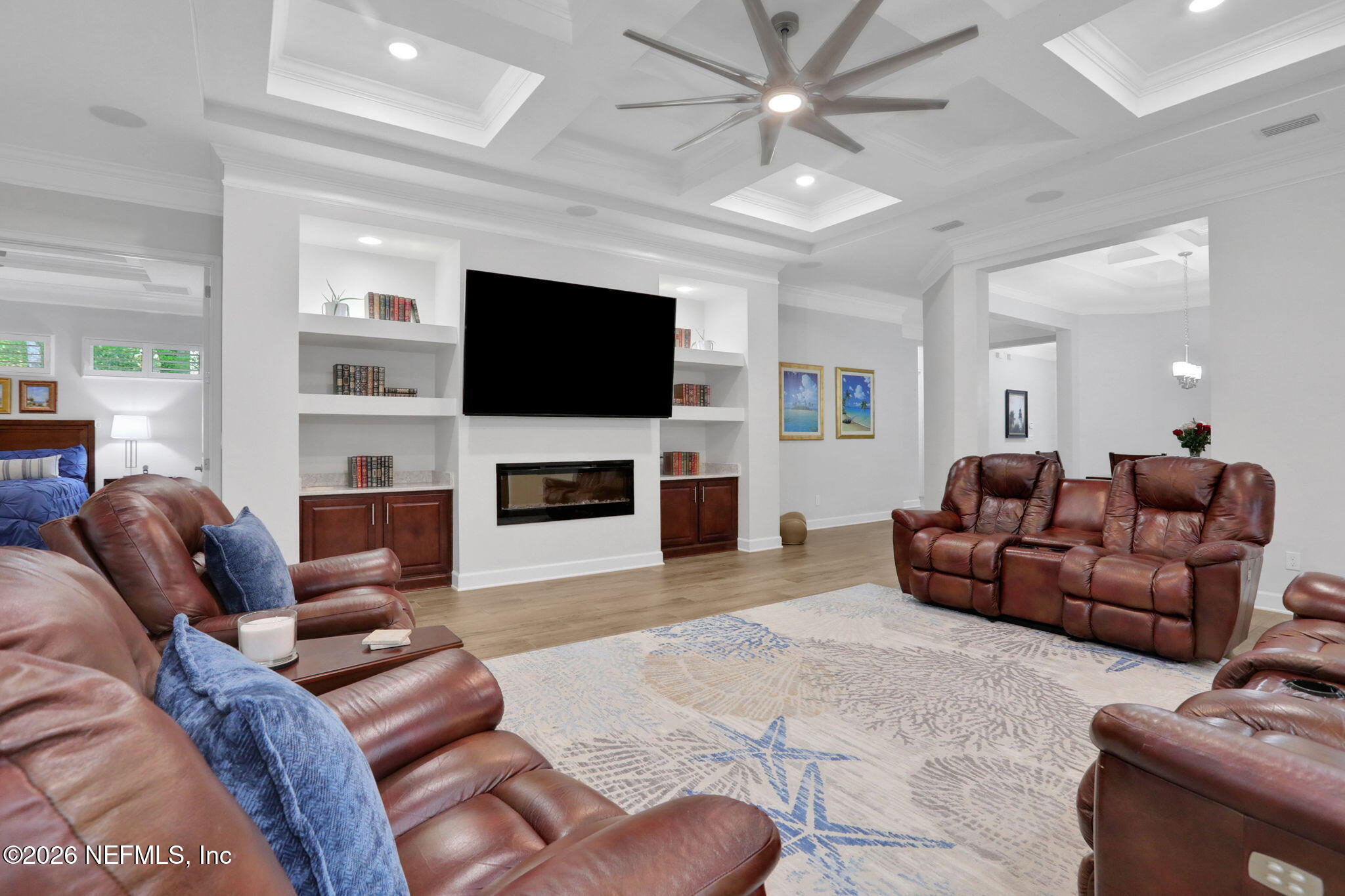 4460 Barkoskie Road Jacksonville, FL 32258 - Photo 16 of 80 a living room with furniture a flat screen tv and a fireplace