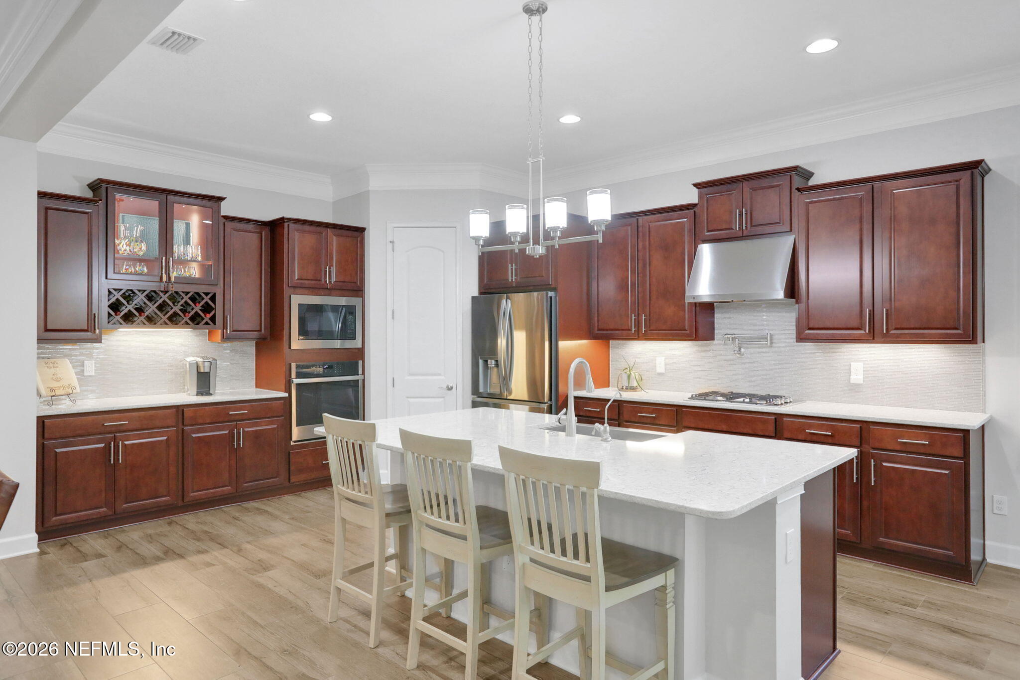 4460 Barkoskie Road Jacksonville, FL 32258 - Photo 17 of 80 a kitchen with stainless steel appliances granite countertop wooden cabinets a stove a sink and a refrigerator