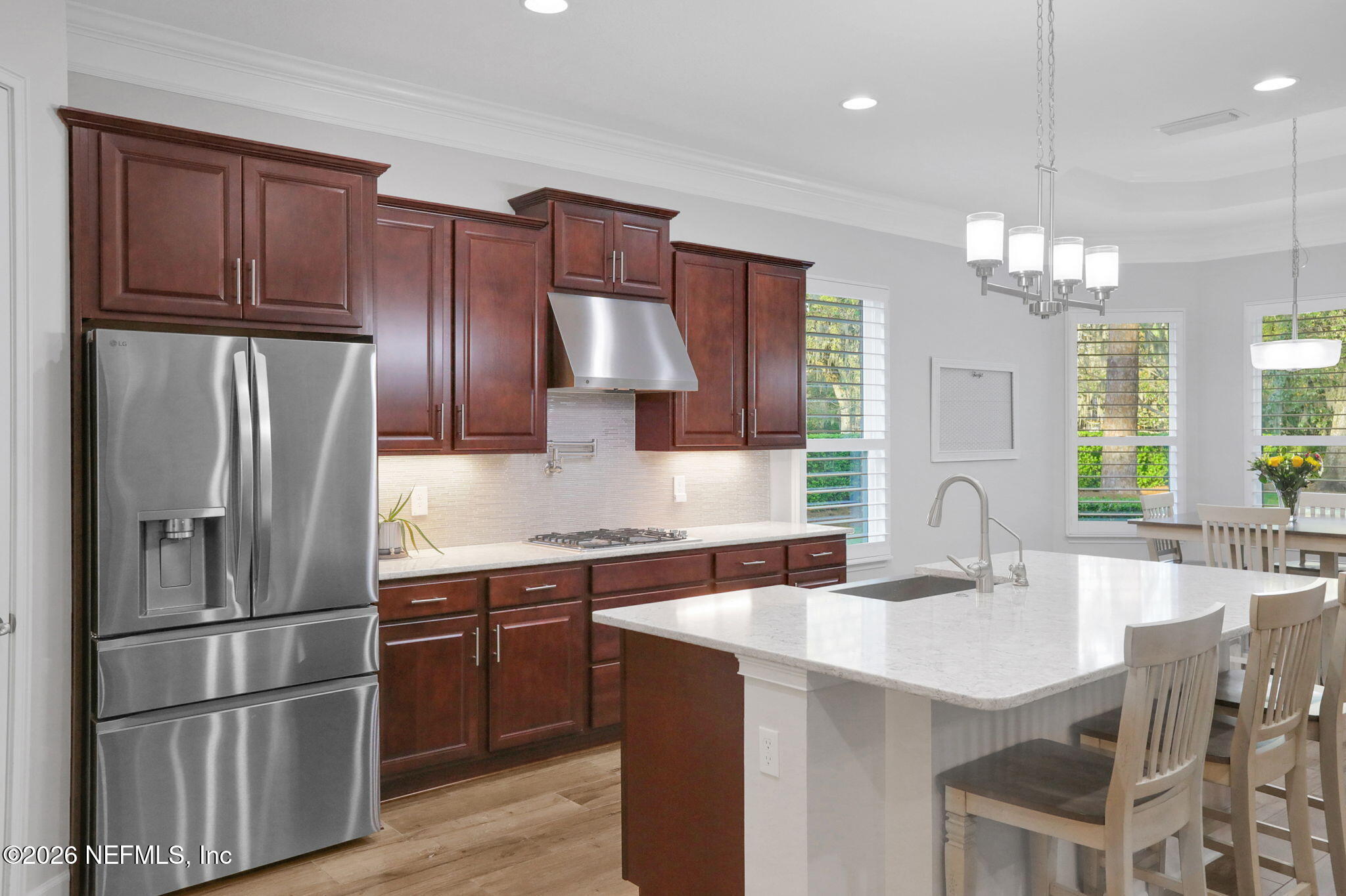4460 Barkoskie Road Jacksonville, FL 32258 - Photo 20 of 80 a kitchen with stainless steel appliances granite countertop a sink refrigerator and cabinets