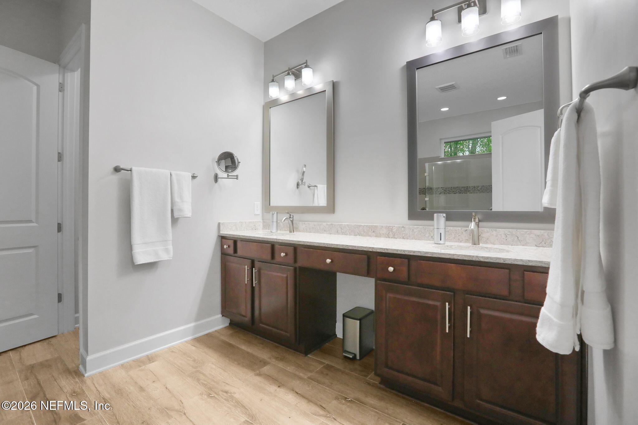 4460 Barkoskie Road Jacksonville, FL 32258 - Photo 33 of 80 a bathroom with a double vanity sink a mirror and shower
