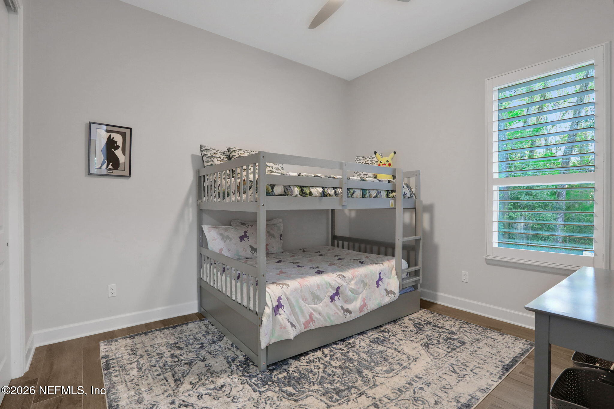 4460 Barkoskie Road Jacksonville, FL 32258 - Photo 40 of 80 a bed sitting in a bedroom next to a window