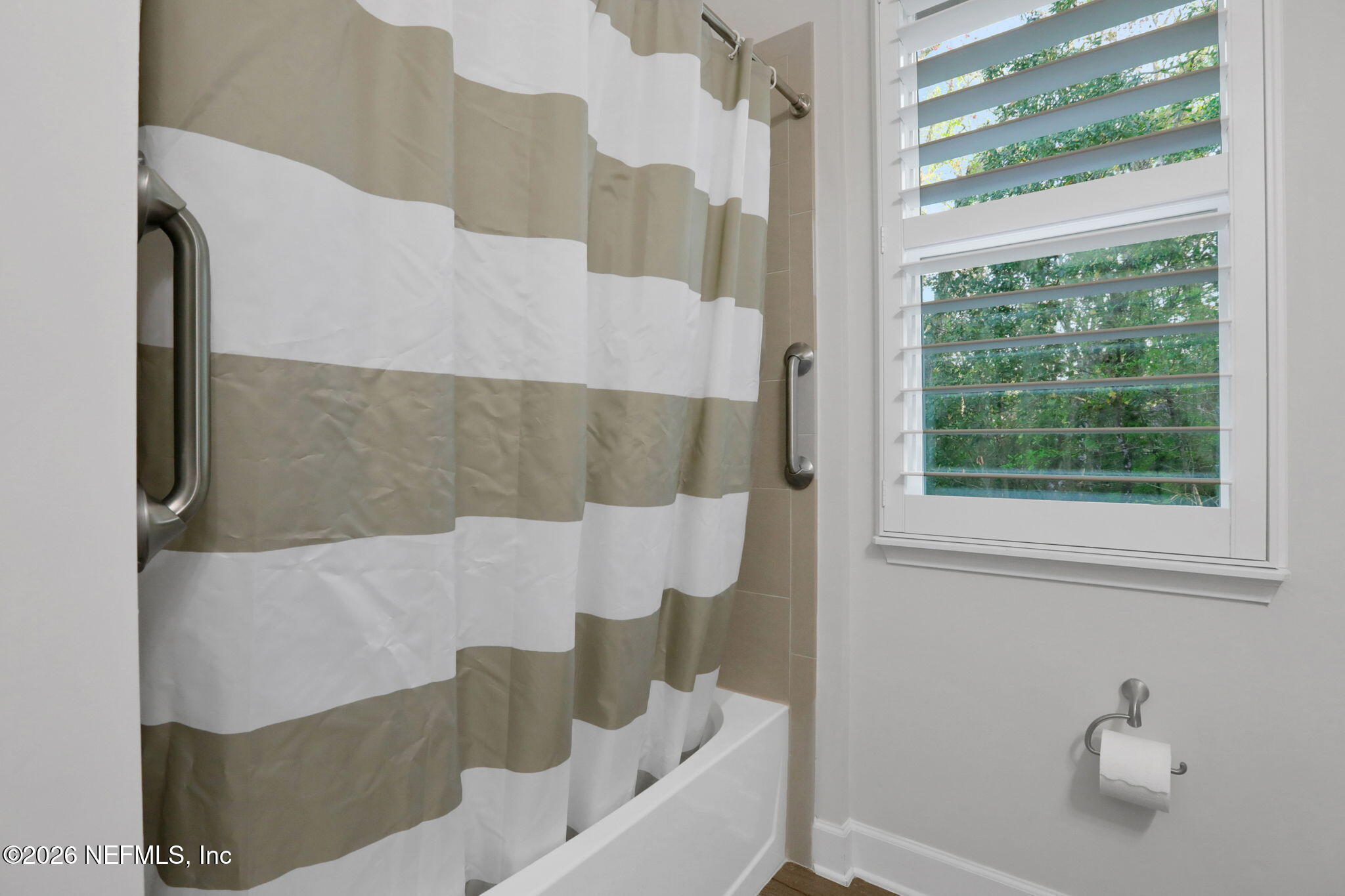 4460 Barkoskie Road Jacksonville, FL 32258 - Photo 41 of 80 a bathroom with a bathtub and next to a window