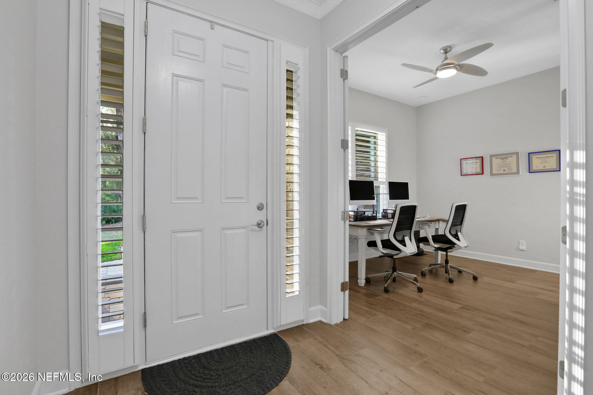 4460 Barkoskie Road Jacksonville, FL 32258 - Photo 8 of 80 a view of a workspace with wooden floor and a ceiling fan