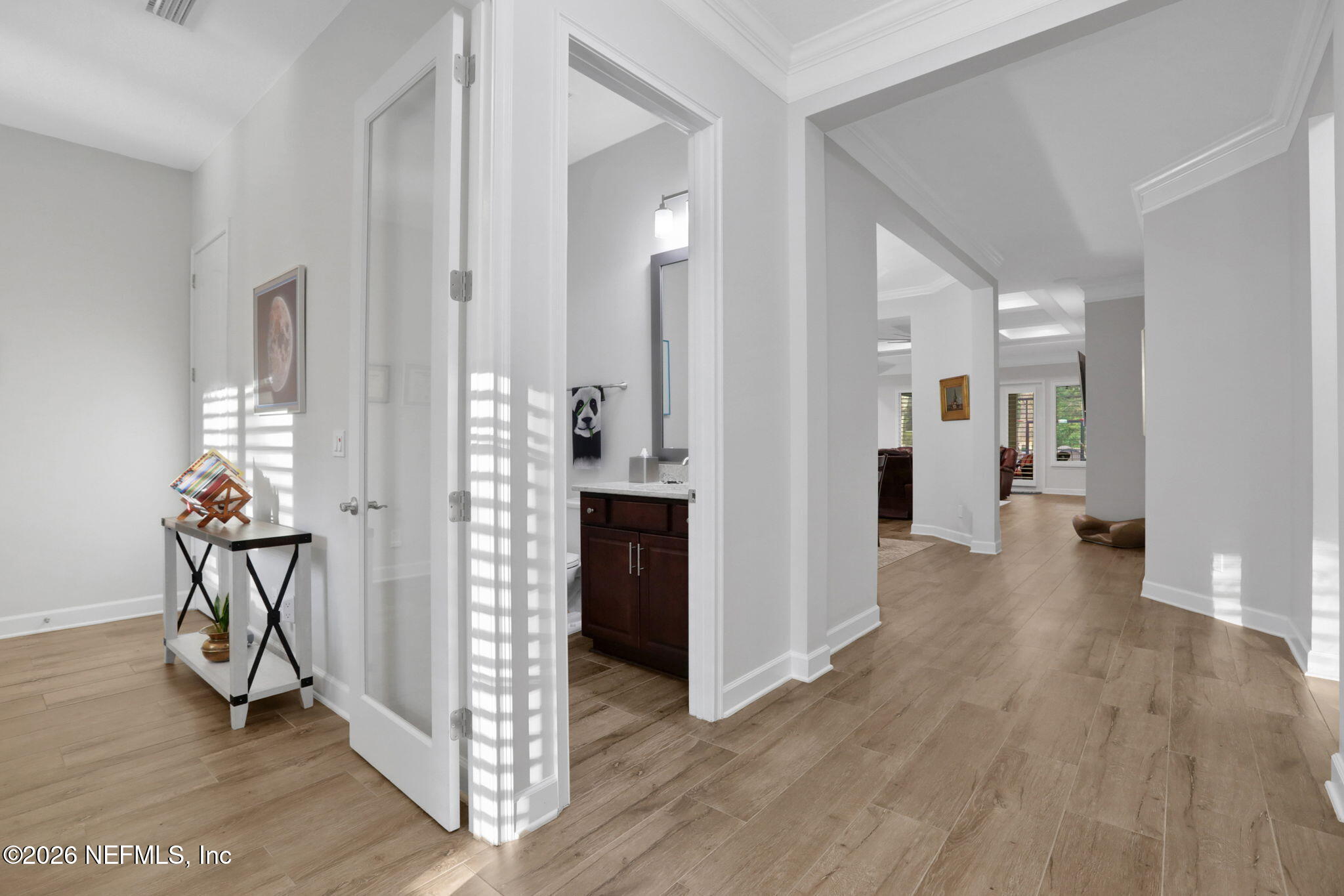 4460 Barkoskie Road Jacksonville, FL 32258 - Photo 9 of 80 a view of a hallway with wooden floor and a living room
