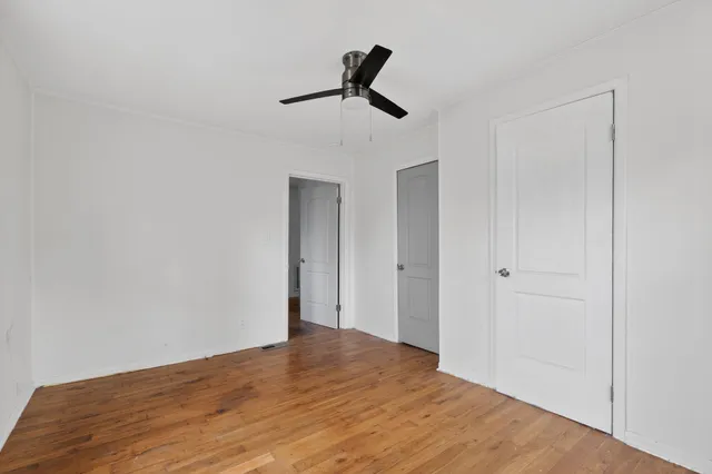 a view of empty room with ceiling fan